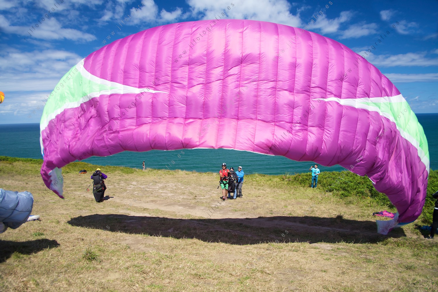 Un parapente se incha con el viento para despegar desde el acantilado de Sopelana