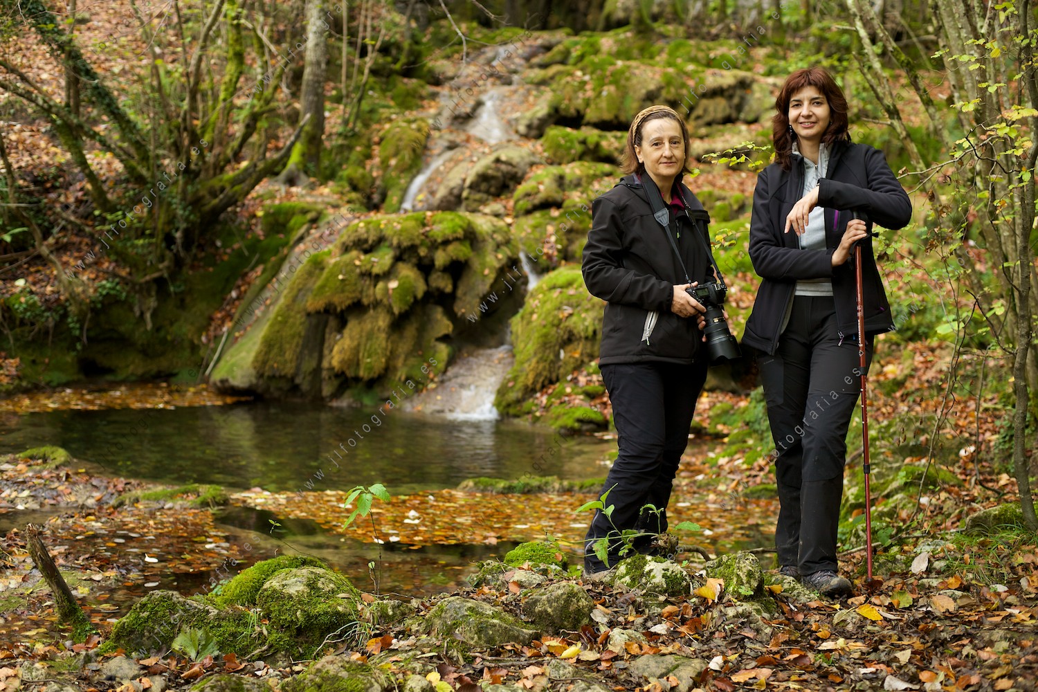 Dos amigas fotógrafas de la asociación fotográfica Denbora posando delante de las cascadas de Tobería en Andoin, un lugar mágico